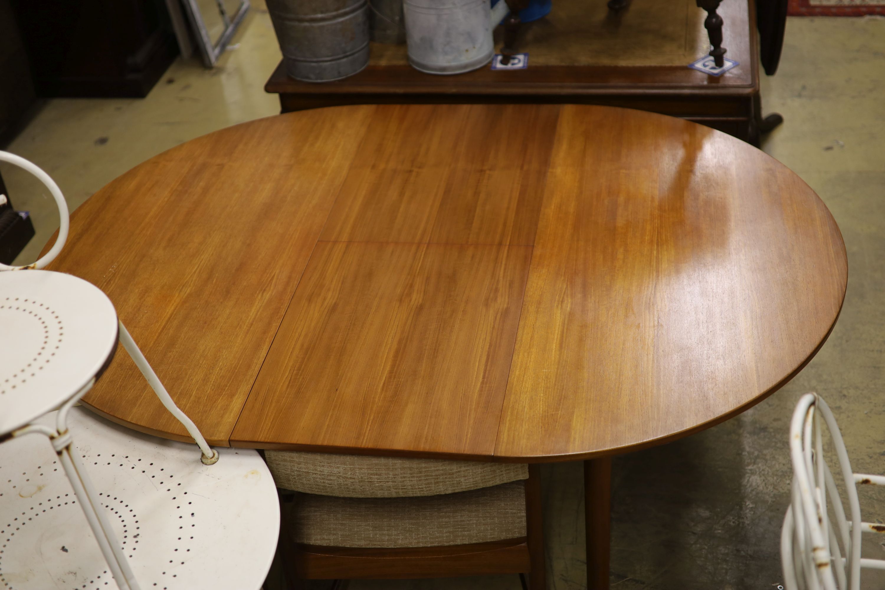 A mid century design Macintosh circular teak extending dining table and four chairs, model 9533, table width 170cm extended depth 122cm height 74cm